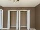 Bedroom closet with open bi-fold doors and adjustable shelving at 2565 Oak Park Way # 213, Orlando, FL 32822