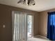 Bedroom with sliding glass door to balcony and vertical blinds at 2565 Oak Park Way # 213, Orlando, FL 32822
