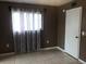 A cozy bedroom with window, blinds, and a closet door at 2565 Oak Park Way # 213, Orlando, FL 32822