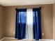 Bedroom featuring large window with blue and white curtains at 2565 Oak Park Way # 213, Orlando, FL 32822