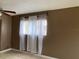 Bedroom featuring a window with blinds and white curtains at 2565 Oak Park Way # 213, Orlando, FL 32822