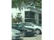 Building exterior with screen patios, greenery, and parking lot with multiple cars at 2565 Oak Park Way # 213, Orlando, FL 32822