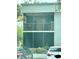 Exterior view of a two-story building featuring screened patio with grill and balcony at 2565 Oak Park Way # 213, Orlando, FL 32822