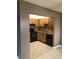 Charming kitchen with wood cabinets, mosaic backsplash, and modern black appliances at 2565 Oak Park Way # 213, Orlando, FL 32822