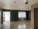 A bright living room featuring neutral tile flooring and a doorway leading outside at 2565 Oak Park Way # 213, Orlando, FL 32822