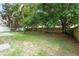 Spacious backyard featuring mature trees and a partial fence at 2708 Smithfield Dr, Orlando, FL 32837