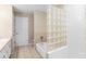Bathroom featuring a tub and shower combo with glass block accents at 2708 Smithfield Dr, Orlando, FL 32837