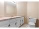 Neutral bathroom featuring a vanity, a toilet, and a large mirror at 2708 Smithfield Dr, Orlando, FL 32837