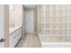 Bright bathroom featuring tiled floors, a tub and glass-blocked shower, and double vanity sinks at 2708 Smithfield Dr, Orlando, FL 32837
