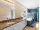 Elegant bathroom featuring granite counters, a tub with blue tile and block window at 2708 Smithfield Dr, Orlando, FL 32837