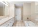 Bright bathroom featuring tiled floors, a tub and glass-blocked shower, and double vanity sinks at 2708 Smithfield Dr, Orlando, FL 32837