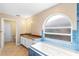 Bright bathroom with tub, window, and tile floor at 2708 Smithfield Dr, Orlando, FL 32837