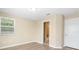 Bedroom with neutral walls and wood-look floors with an open bathroom entrance at 2708 Smithfield Dr, Orlando, FL 32837