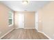 Bright bedroom featuring wood-look floors, neutral walls, and a window offering ample natural light at 2708 Smithfield Dr, Orlando, FL 32837