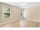 Bright bedroom featuring wood-look floors, neutral walls, and two windows offering ample natural light at 2708 Smithfield Dr, Orlando, FL 32837
