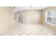 Open dining area featuring tile flooring, contemporary lighting, and natural light from a large window at 2708 Smithfield Dr, Orlando, FL 32837