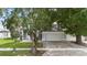 Charming home with a mature tree in the front yard, showcasing its inviting curb appeal at 2708 Smithfield Dr, Orlando, FL 32837