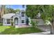 Elegant two-story home featuring arched entryway, lush lawn, and a detached two-car garage at 2708 Smithfield Dr, Orlando, FL 32837