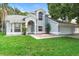 Charming two-story home with a well-manicured lawn, mature landscaping, and a two-car garage at 2708 Smithfield Dr, Orlando, FL 32837