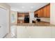 Open kitchen featuring granite countertops, wood cabinetry and black appliances at 2708 Smithfield Dr, Orlando, FL 32837