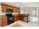 Updated kitchen featuring granite countertops, wood cabinets and black appliances at 2708 Smithfield Dr, Orlando, FL 32837