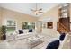 Bright, open living room with white sofas, a coffee table, and large windows offering natural light at 2708 Smithfield Dr, Orlando, FL 32837