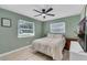 Cozy bedroom with natural light from two windows and a modern ceiling fan at 2720 Kumquat Dr, Edgewater, FL 32141