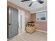 Bright bedroom with natural light, a ceiling fan and view into the kitchen at 2720 Kumquat Dr, Edgewater, FL 32141