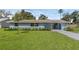 Charming single story home with a well-manicured lawn and appealing landscaping at 2720 Kumquat Dr, Edgewater, FL 32141
