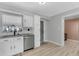 Bright kitchen featuring white cabinets, granite countertops, stainless steel appliances and subway tile backsplash at 2720 Kumquat Dr, Edgewater, FL 32141