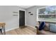 Cozy living room featuring wood-look flooring and a view of the front door at 2720 Kumquat Dr, Edgewater, FL 32141