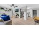 Open living space with wood floors, ceiling fan, and a glimpse of the kitchen at 2720 Kumquat Dr, Edgewater, FL 32141