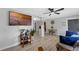 Inviting living room with light-colored flooring, a ceiling fan, and a flat screen television at 2720 Kumquat Dr, Edgewater, FL 32141
