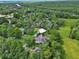 Expansive aerial view of a home nestled amongst lush greenery and the surrounding community near a river at 2770 Red Wing Vlg, Deland, FL 32720