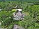 A scenic aerial shot shows a home with solar panels and a sprawling, tree-filled landscape surrounding the property at 2770 Red Wing Vlg, Deland, FL 32720