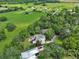 An expansive property view features solar panels on the roof, surrounded by green fields and tree-lined landscapes at 2770 Red Wing Vlg, Deland, FL 32720