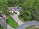 A picturesque aerial view of a home with solar panels, a lush yard, and surrounded by mature trees at 2770 Red Wing Vlg, Deland, FL 32720