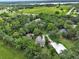 Aerial view of a charming home, surrounded by mature trees and pasture, with solar panels on the roof at 2770 Red Wing Vlg, Deland, FL 32720