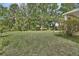 Spacious backyard with a well-kept lawn and mature trees, offering plenty of room for outdoor activities at 2770 Red Wing Vlg, Deland, FL 32720