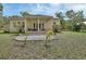Inviting backyard patio with outdoor seating, lush landscaping, and a view of the well-maintained yard at 2770 Red Wing Vlg, Deland, FL 32720