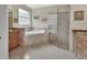 Bright bathroom featuring a soaking tub and glass-enclosed shower with stone accents at 2770 Red Wing Vlg, Deland, FL 32720