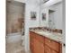 Bathroom featuring a marble countertop vanity, large mirror, and separate bathtub/shower area at 2770 Red Wing Vlg, Deland, FL 32720