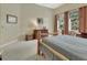 Bright bedroom featuring a cozy wooden bed, neutral walls, and a window with views of the outdoors at 2770 Red Wing Vlg, Deland, FL 32720
