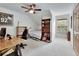 Cozy bedroom with a ceiling fan, built-in bookshelves, and natural light from the window at 2770 Red Wing Vlg, Deland, FL 32720