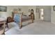 Serene bedroom featuring a light wooden bed frame, carpet flooring, and ample natural light from the windows at 2770 Red Wing Vlg, Deland, FL 32720