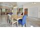 Bright dining area features a large table with unique chairs and an open layout with travertine flooring at 2770 Red Wing Vlg, Deland, FL 32720