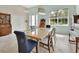 Charming dining area with a piano, a large table with seating for six, and a neutral color palette at 2770 Red Wing Vlg, Deland, FL 32720
