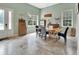 Beautiful dining area with a rustic wood table, comfortable seating, and plenty of natural light from large windows at 2770 Red Wing Vlg, Deland, FL 32720