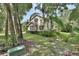Beautiful home nestled among mature trees, with lush landscaping and a stone facade at 2770 Red Wing Vlg, Deland, FL 32720