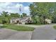 Charming two-story home with well-manicured lawn, mature trees, and a circular driveway at 2770 Red Wing Vlg, Deland, FL 32720